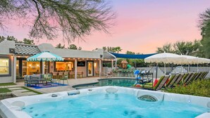 A backyard with a swimming pool, outdoor seating, and a covered patio area. - Scottsdale Retreat Pool Pickleball Spa (Scottsdale)