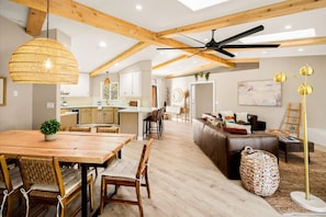 A spacious living area with a wooden dining table, chairs, a sofa, and a ceiling fan. - Sedona Haven 7BR Sleeps 24 Sauna Hot Tubs (Sedona)