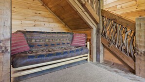 A wooden interior with a sofa, pillows, and a decorative wall. - Mtn Cabin w Hot Tub Game Room Grill Views (Blue Ridge)