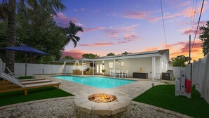A backyard with a swimming pool, a fire pit, and outdoor furniture. - Coastin Close Family Fun HTD Pool Outdoor Games (Pinellas Park)