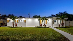 A modern two-story house with a well-maintained lawn and a pathway leading to the entrance. - Sports Court Playground Putt Putt Spa Pool (Bradenton)