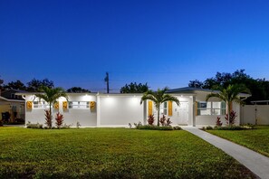 A modern two-story house with a well-maintained lawn and a pathway leading to the entrance. - Sports Court Playground Putt Putt Spa Pool (Bradenton)