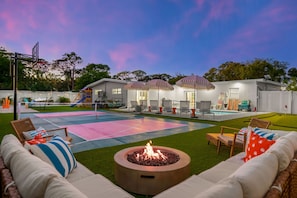 A backyard with a pool, outdoor seating, a fire pit, and a basketball court. - Sports Court Playground Putt Putt Spa Pool (Bradenton)