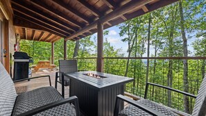 An outdoor deck with a grill, seating, and a fire pit. - MTN Views Hot Tub Fire Pit Pool Table Games (Morganton)