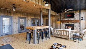 A wooden interior with a bar area, seating, and a fireplace. - 2-level Deck - Stunning Views - Hot Tub - Fire Pit (Ellijay)