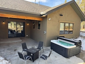 A covered patio with a hot tub, outdoor seating, and a view of a mountainous landscape. - 34 Acre Escape Games Hiking Pool Table Bicycles (Black Hawk)