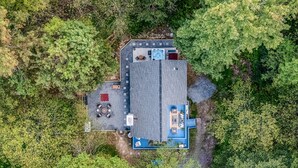 An aerial view of a property with a large building, outdoor seating area, and a hot tub. - Poconos Pines Escape Sauna Hot Tub Playground (Pocono Lake)