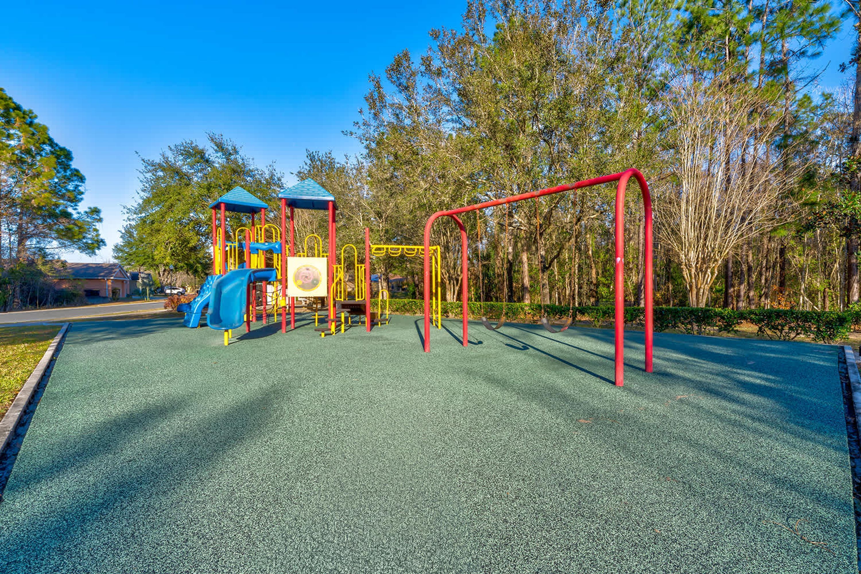 A playground with a slide, swings, and climbing structures.