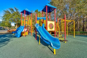 A playground with slides and climbing structures. - 12 min to Disney Movie Theater Pool In-ground spa (Davenport)