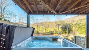 A hot tub under a wooden pergola with a view of a green landscape. - Mountain Retreat Sauna Outdoor Dining Nature (Asheville)