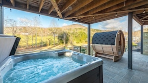 A hot tub and sauna under a wooden roof with a view of a hilly landscape. - Mountain Retreat Sauna Outdoor Dining Nature (Asheville)