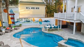 A pool area with lounge chairs, a basketball hoop, and a deck with a railing. - Burkes Beach Reserve Golf Sim Pickleball Sleeps 24 (Hilton Head Island)