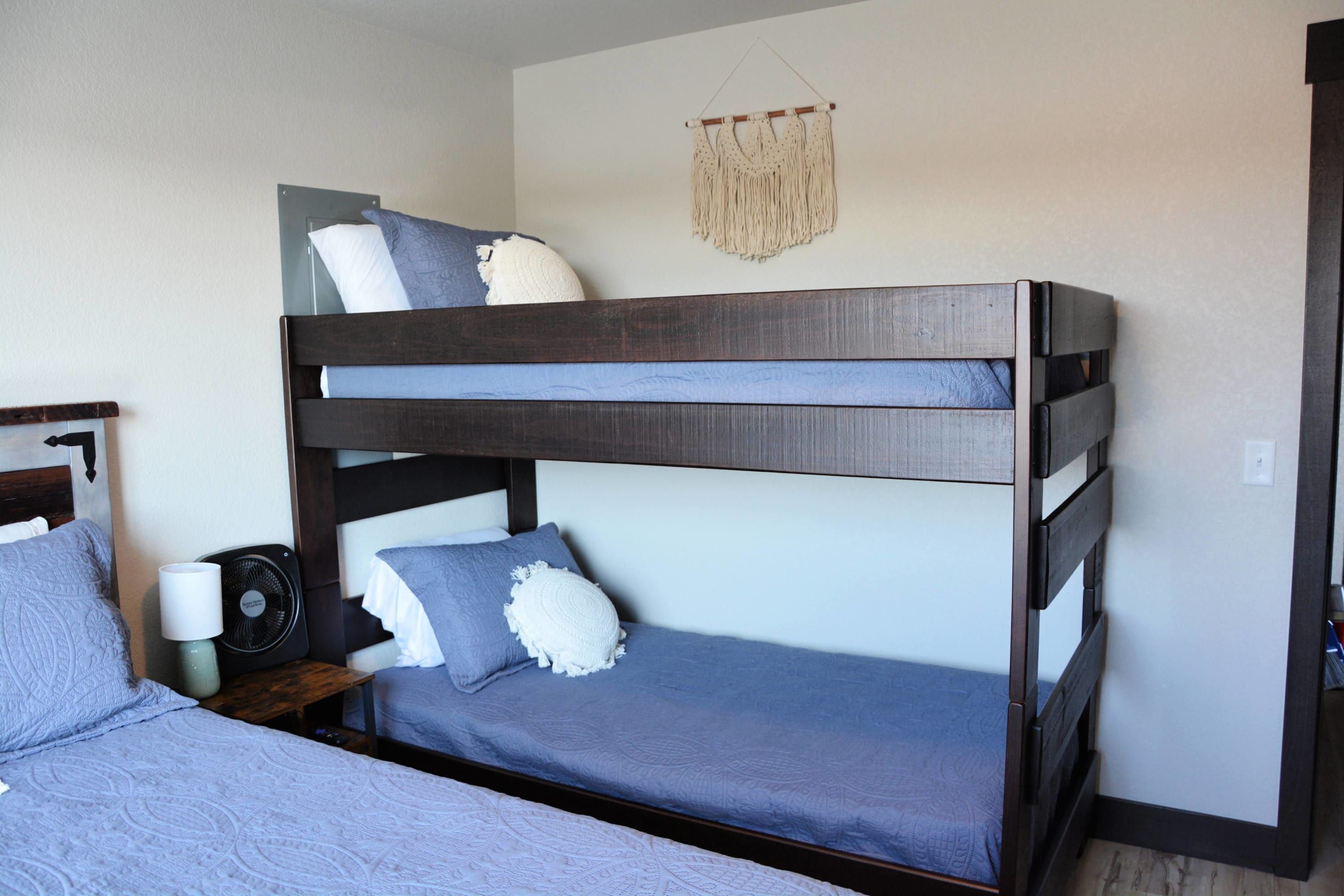 A bunk bed with a lower bunk and a headboard.