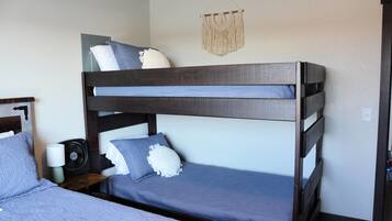 A bunk bed with a lower bunk and a headboard.