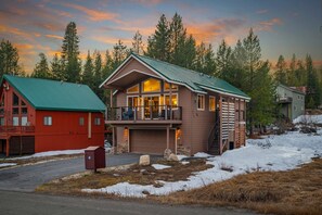 A two-story house with a green roof, a garage, and a balcony. - Mountain Retreat Canoe Fireplace Views (Soda Springs)