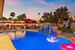 A swimming pool with a water feature, lounge chairs, and a children's play area. - The Desert Reserve Pool Sport Court 7BR (Scottsdale)