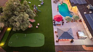 A rooftop with a basketball court, a swimming pool, and solar panels. - The Desert Reserve Pool Sport Court 7BR (Scottsdale)