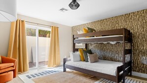 A bunk bed with a patterned wall, a sliding glass door, and a striped rug. - The Desert Reserve Pool Sport Court 7BR (Scottsdale)