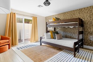 A bunk bed with a patterned wall, a sliding glass door, and a striped rug. - The Desert Reserve Pool Sport Court 7BR (Scottsdale)