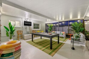 A modern living room with a pool table, comfortable seating, and a TV labeled 'Home Team.' - Epic Backyard - Pool - Hot Tub - Outdoor Theatre (Bradenton)
