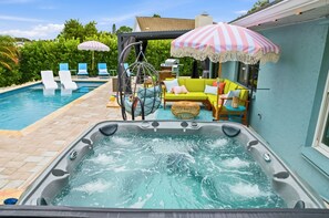 A hot tub with a pool, lounge chairs, and a colorful sofa. - Bradenton Bliss Pool Putt Putt Arcade Games (Bradenton)