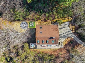A two-story building with a flat roof, surrounded by dense vegetation. - Mtn Views Stargazing Dome Hot Tub Sleeps 20 (Fairview)