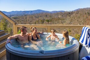A hot tub with a wooden deck and a view of mountains. - Mtn Views Stargazing Dome Hot Tub Sleeps 20 (Fairview)
