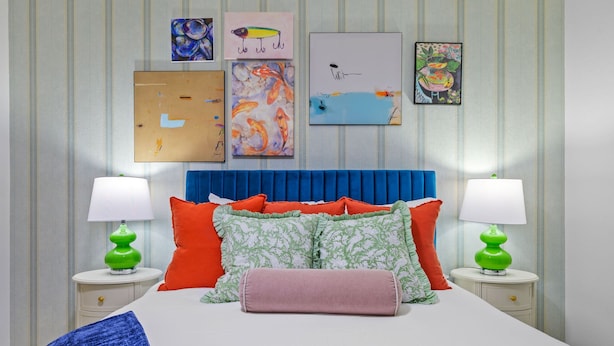 A bedroom with a bed, pillows, two bedside tables, and wall art. - Basketball Pickleball Pool Movie Game Room (Largo)
