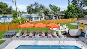 A swimming pool with lounge chairs and umbrellas, a hot tub, and a ping pong table. - Basketball Pickleball Pool Movie Game Room (Largo)