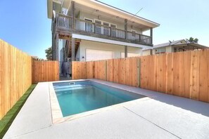 A two-story house with a swimming pool in the backyard. - Nauti Paradise- Private Pool Game Room (Port Aransas)