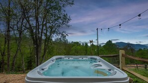 A hot tub with a view of a forest and mountains in the background. - Sleeps 20 Hot Tub Outdoor Theater Fire Pit Games (Fairview)