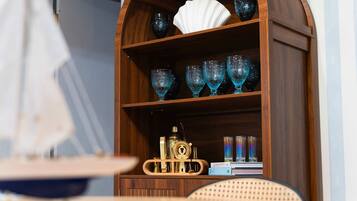 A wooden cabinet with glassware and a decorative item.