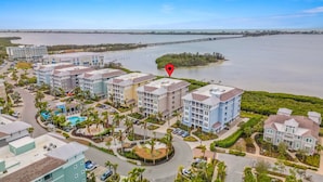 A coastal hotel with multiple buildings, a swimming pool, and a view of the sea. - Bradenton Retreat-pool Stunning Views More (Bradenton)