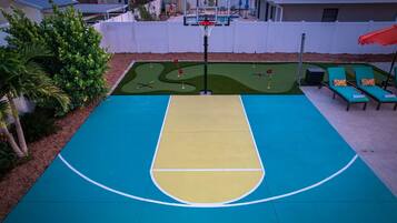 Una cancha de baloncesto con una mesa de billar al lado.