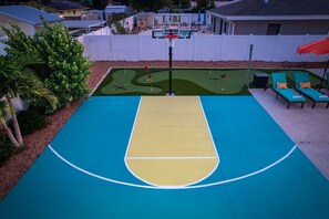 A basketball court with a pool table adjacent to it. - Basketball Court Game Room Pool Hot Tub (Largo)