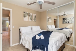 A bedroom with two beds, a ceiling fan, and artwork on the walls. - Minutes to Wineries Outdoor Oasis Pool Table (Murrieta)