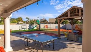An outdoor recreational area with a ping pong table, a basketball court, and a children's play structure. - Sleeps 19 Pool Sport Court Putt Putt Gym (Mesa)