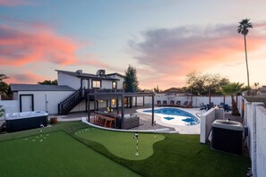 A residential backyard with a swimming pool, a hot tub, and a covered patio area. - Piece of Paradise Pool Games Fire Pit Hot tub (Glendale)
