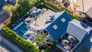 An aerial view of a property with a swimming pool, outdoor seating, and a covered patio area. - Luminosity Escape Pool Hot Tub Dog-friendly (Scottsdale)