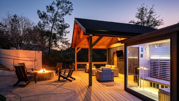 A covered outdoor area with a fire pit, seating, and a glass enclosure. - Prime Sequoia Stay Pool Hot Tub Sauna Views (Three Rivers)