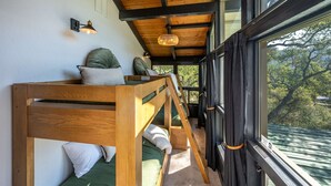 A cabin interior with wooden bunk beds, a large window, and a view of the outdoors. - Prime Sequoia Stay Pool Hot Tub Sauna Views (Three Rivers)