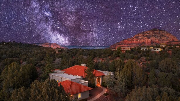 A residential area with a house featuring a red-tiled roof, surrounded by trees and a mountain in the background. - NEW Heated Pool Outdoor Fun Hottub Games More (Sedona)