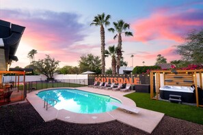 A swimming pool with lounge chairs, palm trees, and a sign that reads 'SCOTTSDALE'. - The Sunkiss Pickleball Heated Pool Hot Tub (Scottsdale)