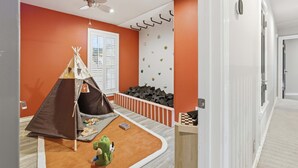 A child's playroom with a tent, climbing wall, and a ceiling fan. - Ultimate Backyard Pool Game Room Kid s Room (San Antonio)