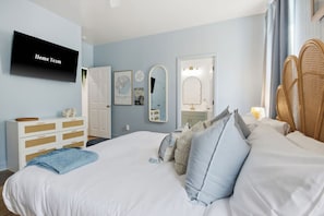 A bedroom with a bed, a dresser, a mirror, and a television on the wall. - Golf Sim Theater Games Walk to Beach Sleeps 28 (North Myrtle Beach)