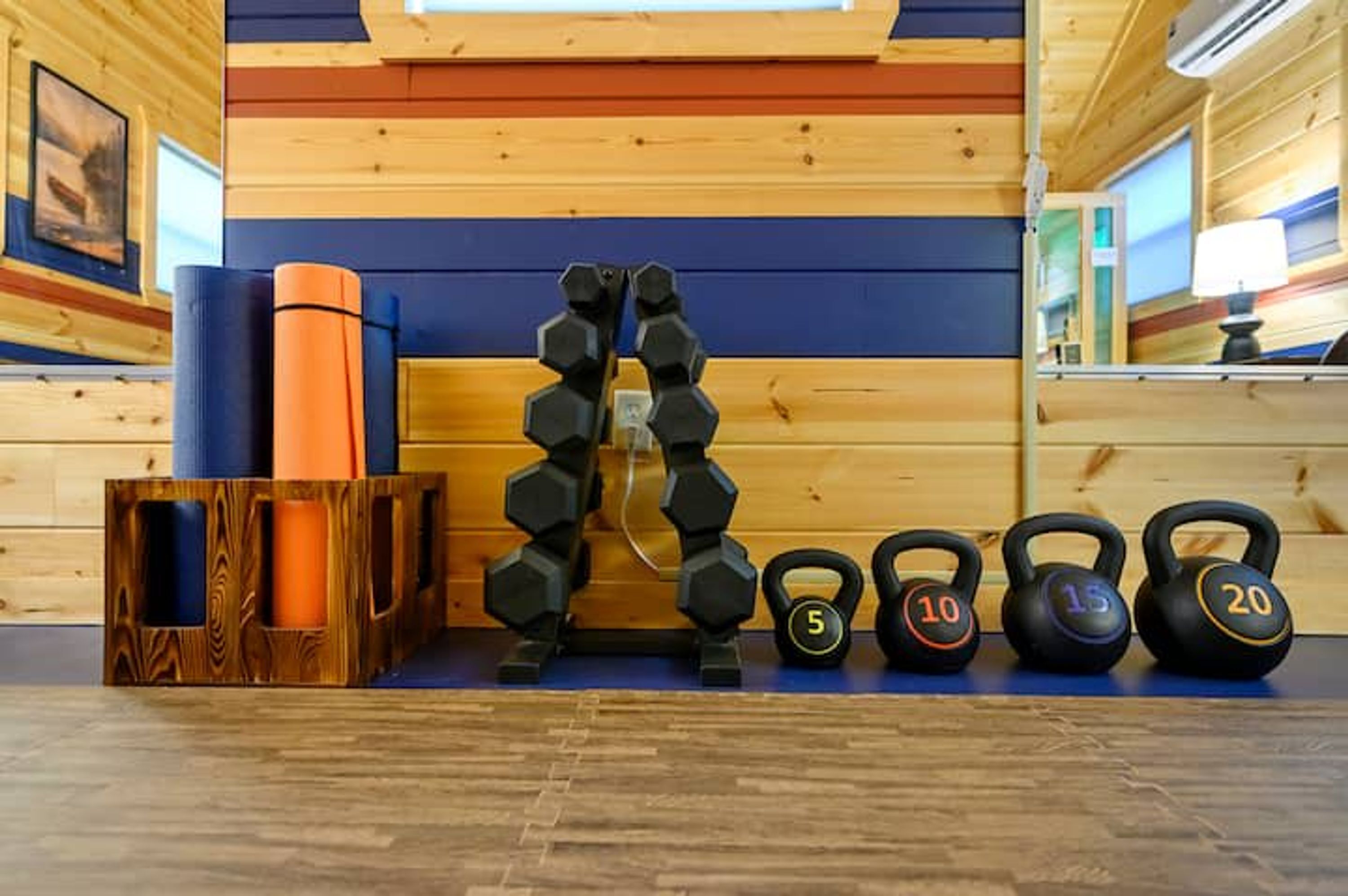 A gym with various weights and exercise equipment.