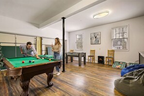 A room with a pool table, a foosball table, and a fireplace. - Sleeps 14 Hot Tub Sauna Game Room Fire Pit (Long Pond)