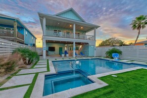 A two-story house with a swimming pool, a balcony, and a view of the sunset. - Glory Daze Private Pool Ice Maker EV Charger (Port Aransas)