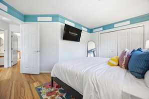 A bedroom with a bed, a television, a mirror, and a door. - Sleeps 20 Sport Court Game Room Sauna Spa (Asheville)