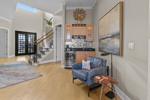 A modern interior with a staircase, kitchen, and seating area. - Luxury Waterfront 4Br Private Heated Pool Hot Tub (St. Petersburg)
